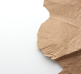 fragment of crumpled blank sheet of brown wrapping kraft paper with torn edges