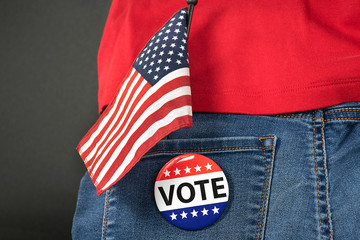 Wall Mural - election vote pin on blue jean pocket with American flag and red shirt