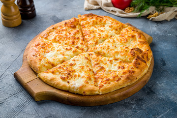 Wall Mural - khachapuri with cheese on wooden table
