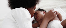 Portrait Of Sleeping African American Baby Girl With Mother