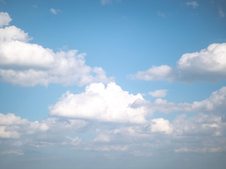 Wall Mural - gorgeous white fluffy cumulus clouds floating in a bright blue sky on a sunny summer day.
