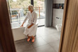 © Yakobchuk Olena - Smiling old woman sitting on the edge of bathtub