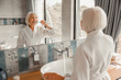 © Yakobchuk Olena - Lovely old lady brushing teeth in bathroom