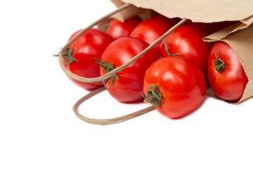 Fresh healthy tomatoes in an eco bag isolated on a white background. Shopping of organic and vegetarian food. Zero waste, eco friendly or plastic free lifes