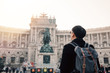 © twinsterphoto - Back view portrait of Asian male tourist backpacker carrying a bag in Hofburg palace in Vienna, Austria, Europe