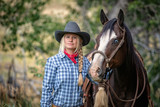Fototapeta Konie - cowgirl and horse