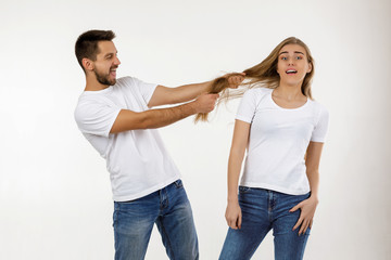 Wall Mural - beautiful happy couple having fun on white background.