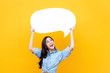 © Atstock Productions - Excited young beautiful Asian woman holding and looking up to speech bubble