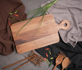 A butcher and kitchen instrument on the table set with many clothes.