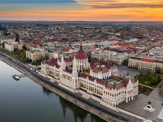 Wall Mural - Budapest, Hungary - Aerial drone view of the beautiful Parliament building of Hungary on a calm summer morning with golden clouds and blue sky