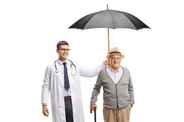 Sticker - Young male doctor holding an umbrella over a senior man