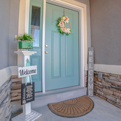 Wall Mural - Square frame Green entrance door with floral wreath near sunset