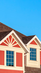 Vertical Colorful red house with white accents near sunrise