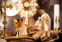Catholic Concept Background.  The Cross, Monstrance, Jesus Figure, Holy Bible And Golden Chalice On The Rustic Wooden Table.