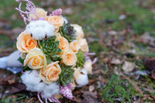 The Bride's Bouquet With Pink And White Flowers And Greenery On The Ground