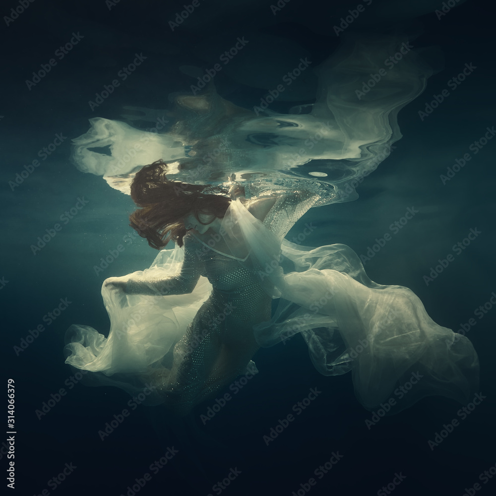 Portrait of a girl in a dress floating underwater Stock Photo | Adobe Stock