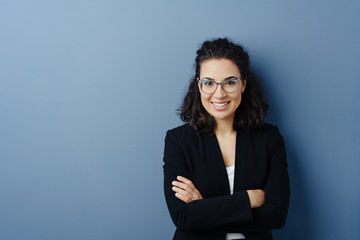 young woman with folded arms and cheerful smile