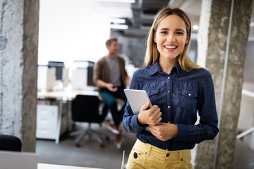 Sticker - Beautiful business woman holding tablet computer in office