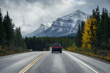 Road Trip On Highway With Rocky Mountains In Autumn Forest At Banff National Park