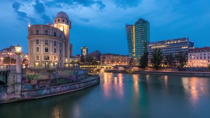 Wall Mural - Panoramic view of Urania with other buildings and Danube Canal day to night transition timelapse in Vienna. Urania is a public educational institute and observatory