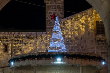 Night  view of a street decorated for Christmas celebrations in the old part of Nazareth in Israel