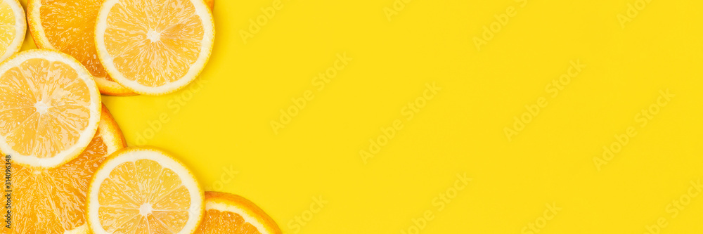 Juicy citrus on a yellow background. Bright vitamin photo. Copy space, web-banner format. - obrazy, fototapety, plakaty 