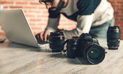 Wall Mural - photographer hand camera working in desk