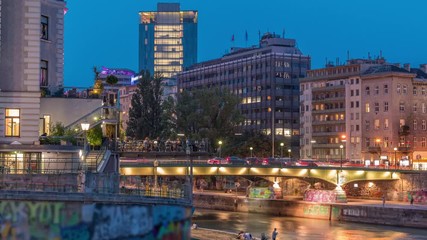 Wall Mural - Vienna cityscape with the Danube channel day to night transition timelapse in Vienna. Austria. Buildings with green trees and bridge with traffic