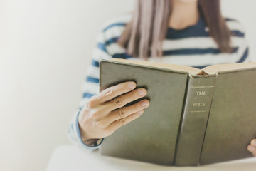 Wall Mural - Woman holding the open bible in hands with copy space.