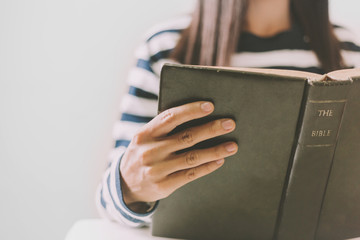 Wall Mural - Woman holding the open bible in hands with copy space.