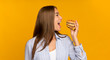 Happy Girl Eating Unhealthy Burger Standing On Yellow Background, Panorama