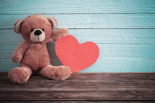 Teddy Bear With Red Heart On Old Wooden Background. Valentine's Day Concept