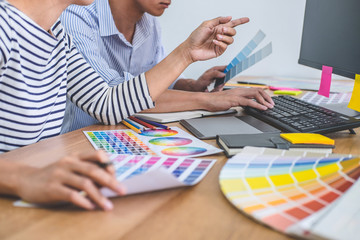 Poster - Two colleagues creative graphic designer working on color selection and drawing on graphics tablet at workplace, Color swatch samples chart for selection coloring