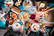 © simona - Vertical view of table with blue dishes and lot of coloured food - people in firendship enjoy eating together in party celebration at home for holiday