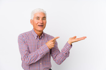 Wall Mural - Senior caucasian man isolated excited holding a copy space on palm.