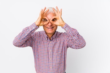 Wall Mural - Senior caucasian man isolated showing okay sign over eyes