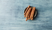 Ceylon Cinnamon Sticks On Blue Wooden Background. Natural Spices