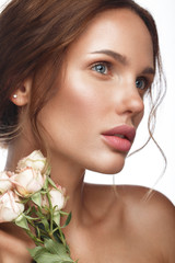 Wall Mural - beautiful woman with classic nude make-up, light hairstyle and flowers. beauty face.