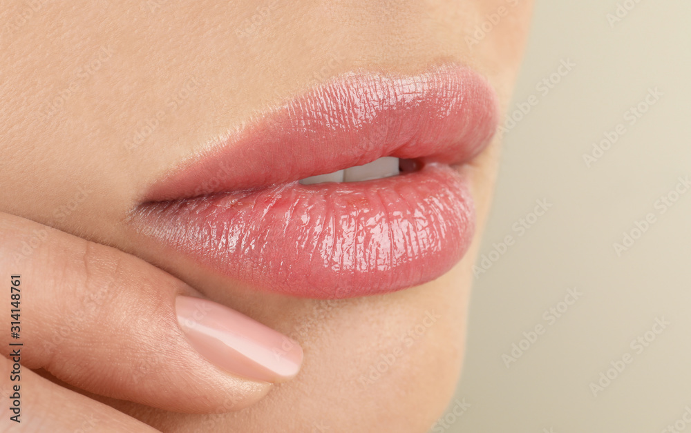 Woman with beautiful full lips on beige background, closeup - obrazy, fototapety, plakaty 