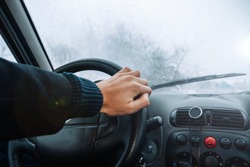 Wall Mural - driving a car on a winter snowy day. Cold ride.