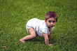 © RAOTA - baby boy crawls on the lawn of the garden