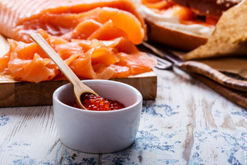 Cured salmon served  with cream  cheese, bagel, pot of  salmon caviar