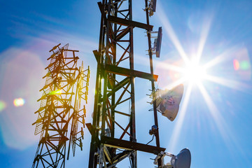 an abstract view of two cellular base station towers, steel lattice design with electronic communica