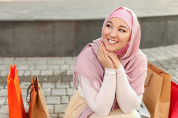 Sticker - Beautiful Muslim woman with shopping bags outdoors