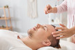 © Pixel-Shot - Reiki master working with patient