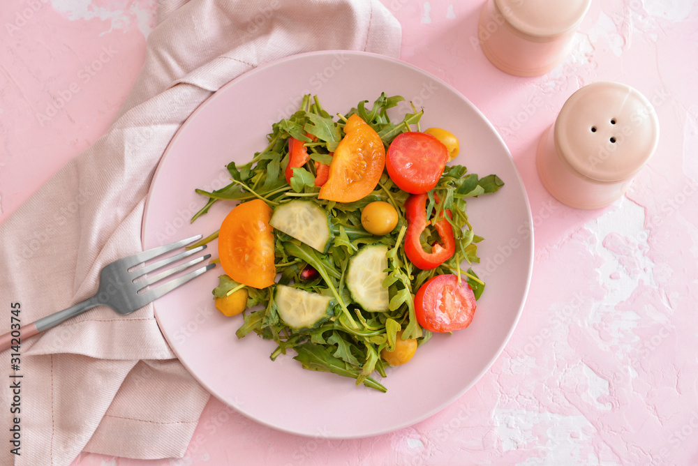 Plate with tasty salad on table