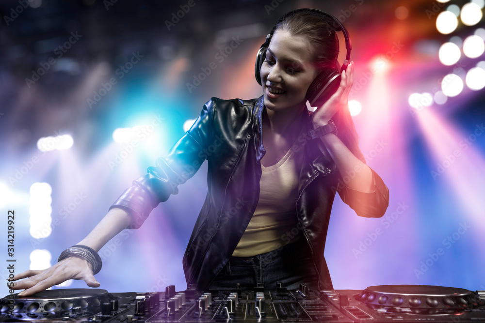 Female dj in nightclub. Mixed media - obrazy, fototapety, plakaty 