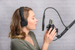 © Anton - The girl works in a recording studio. Sound recording, and news. News report.