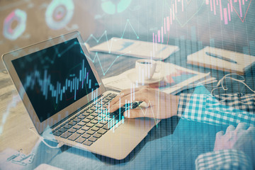 Double exposure of forex chart with man working on computer on background. Concept of market analysis.