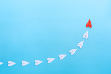 Leadership Concept With Red Paper Plane Leading Among White Paper Planes On Blue Background. Copy Space